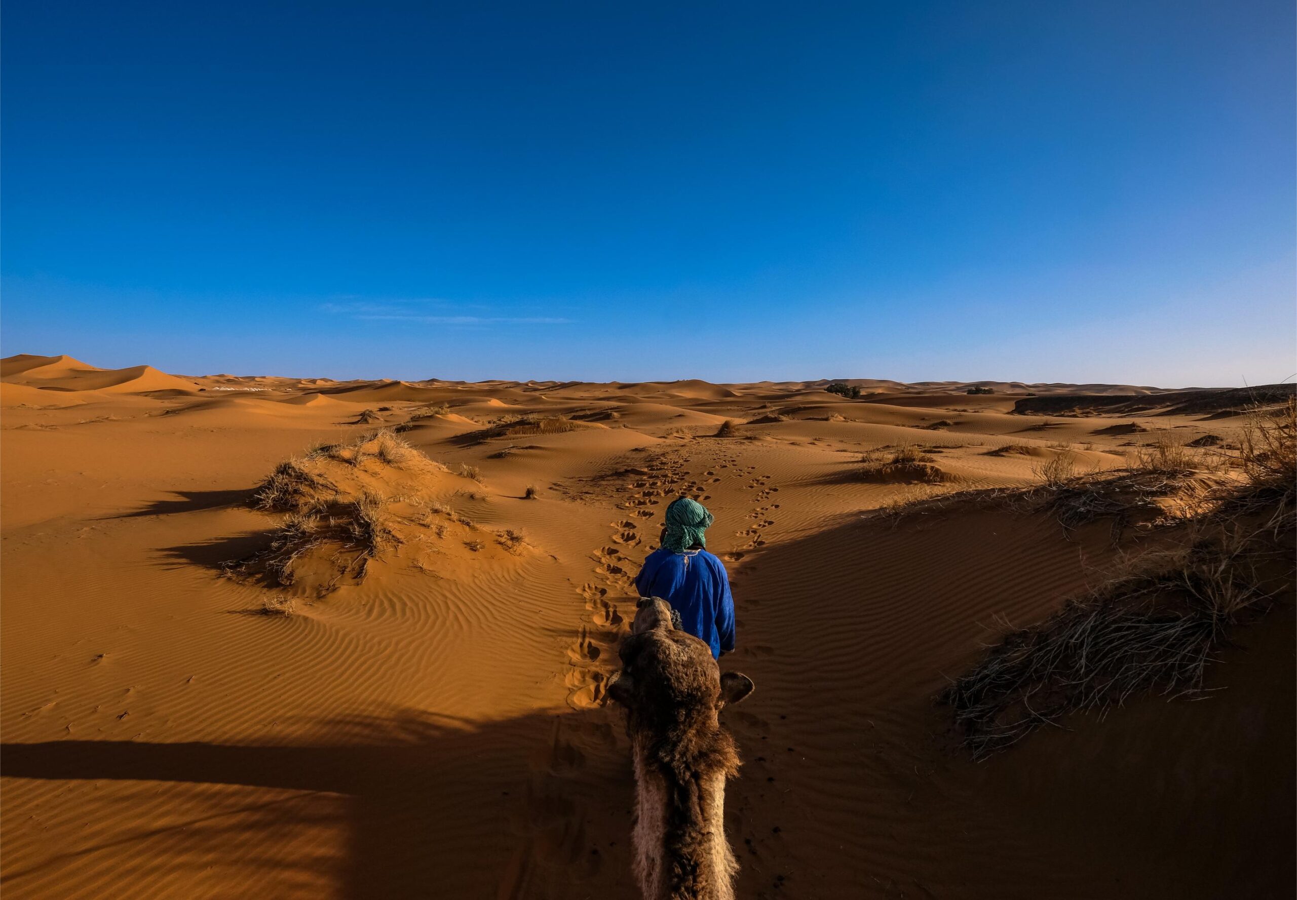 Traditional tea ceremony at sunset on the Erg Ezzahar dunes, Morocco